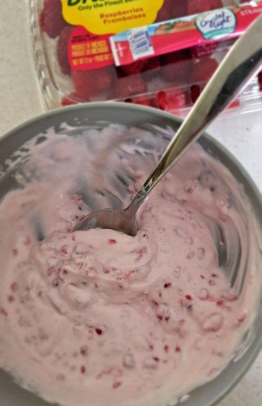 Greek yogurt with mashed raspberries.